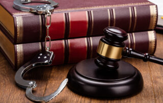 gavel-and-handcuffs-with-red-legal-book-on-wooden-table